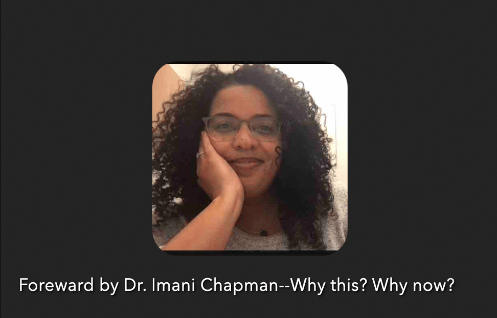 Imani, afrolatina with long curly hair, with glasses, looks at the camera with her hand on her chin